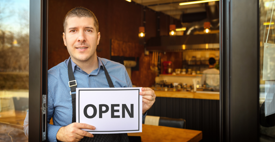 Business owner with open sign